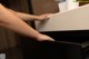 A woman is opening a drawer in a kitchen.