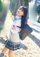 a japanese girl in a school uniform is posing for the camera