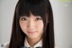 A young woman with long black hair wearing a school uniform.
